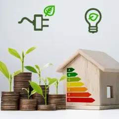 Piccola casa in legno con simboli di risparmio energetico: acqua, elettricità, lampadina, termometro. Piantine crescono su pile di monete, simbolo di investimento nel risparmio energetico in casa.