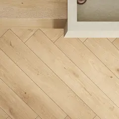 Dettaglio di un pavimento in legno con posa a spina di pesce, che mostra eleganti schemi posa piastrelle.