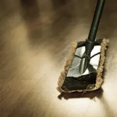 Un mocio su un pavimento in legno, pronto per iniziare a lavare il pavimento.