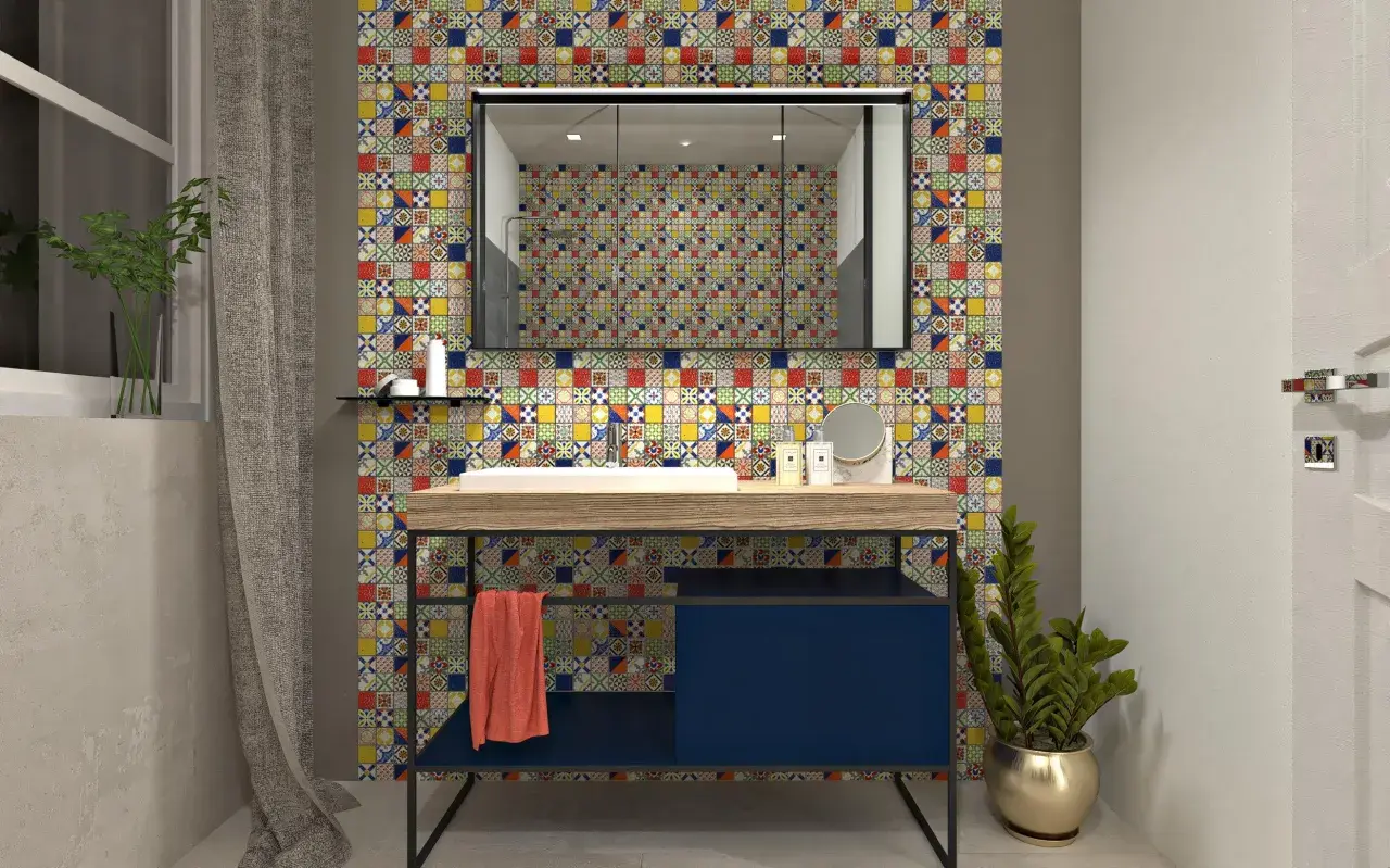 Un bagno moderno con un lavabo su un mobile blu scuro, incorniciato da un vivace **boxer mosaico** che riveste la parete.
