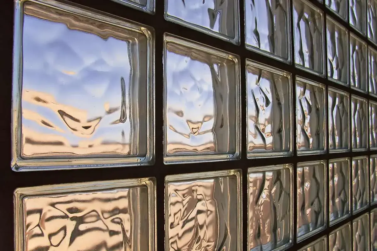 Muro di vetrocemento con riflessi del cielo. Lo spessore del vetrocemento crea un effetto ondulato.