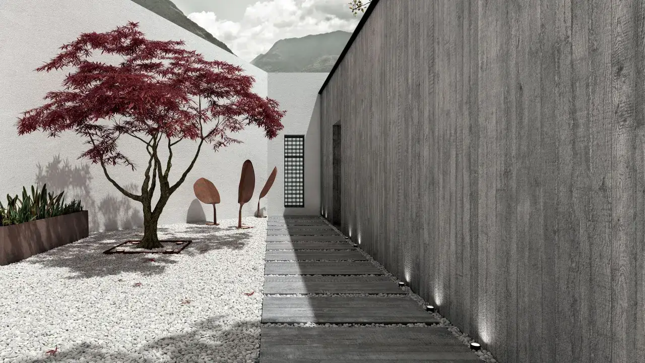Un giardino zen con un acero rosso fiammante, ghiaia bianca e un sentiero in pietra, che evoca la tranquillità del Cotto d'Este.