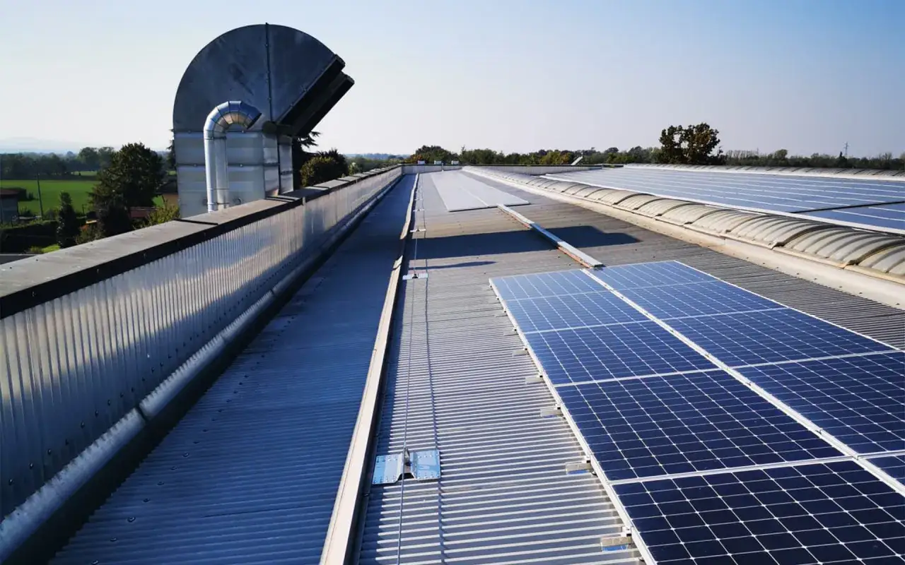 Pannelli solari su un tetto industriale, un lavoro di rifare il tetto con pannelli coibentati che promette efficienza energetica.